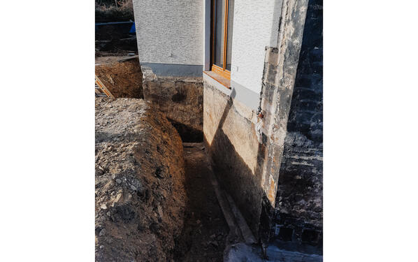 The moisture on the outer wall had to be removed as part of refurbishing the basement.